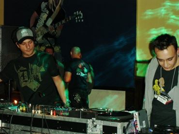 Michael Darius Eastwood on the decks beside Andy C at a live drum and bass event, both at the mixer